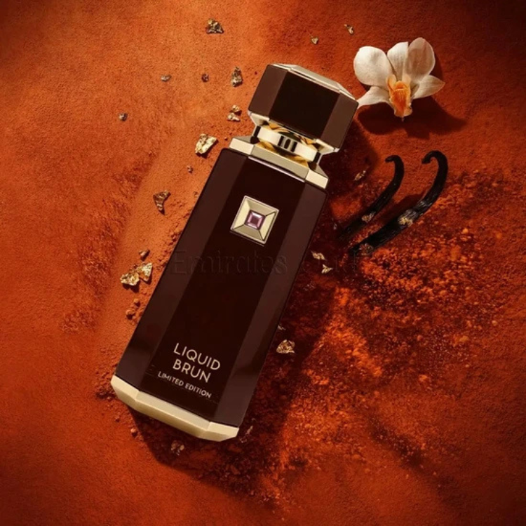Perfume bottle labeled 'Liquid Brun' on a textured brown surface with flowers and gold elements. in Qatar