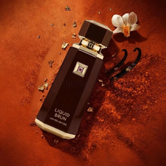 Perfume bottle labeled 'Liquid Brun' on a textured brown surface with flowers and gold elements. in Qatar